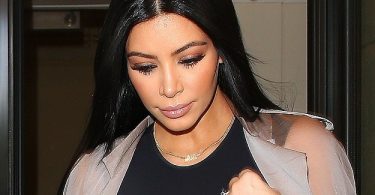 Kim Kardashian reveals her ample assets in a sheer bra top