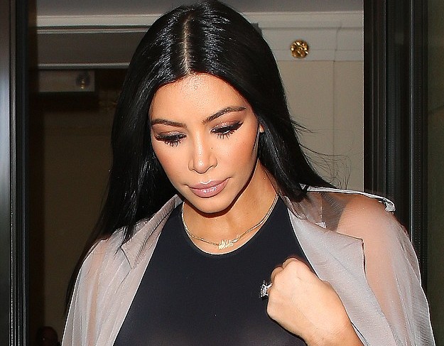 Kim Kardashian reveals her ample assets in a sheer bra top