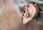 Elderly woman wearing a hearing aid