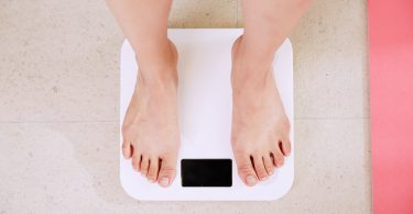 person measuring their weight