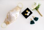 image of a mask with earrings and a bouquet