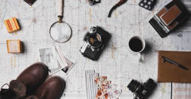 Travel Essentials Scattered On A Map
