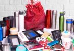 Assorted promotional products, including thermoses, mugs, gifts, sleep masks, power banks, pens in boxes, and notebooks.