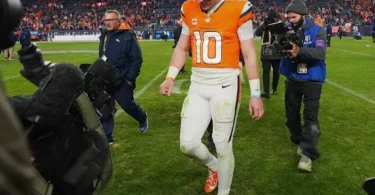 Bo Nix leaving the field after ankle injury with the Denver Broncos