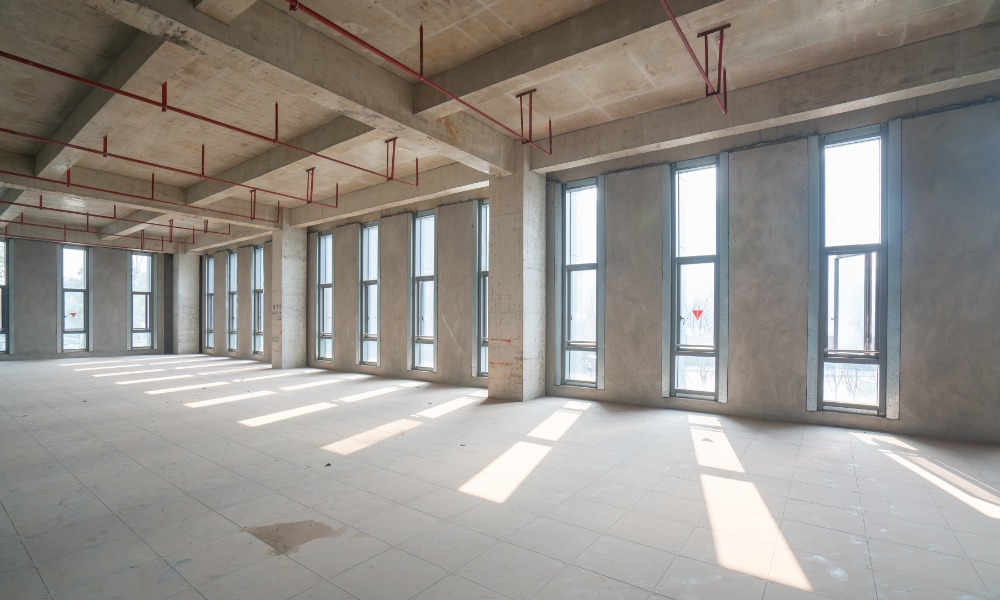 A large commercial space with concrete walls and a concrete floor. The space in undecorated.