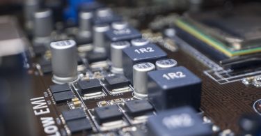 A close-up of the elements of a computer motherboard with identifications like "1R2" and "Low EMI" labeled at the top.
