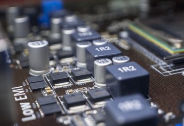 A close-up of the elements of a computer motherboard with identifications like "1R2" and "Low EMI" labeled at the top.