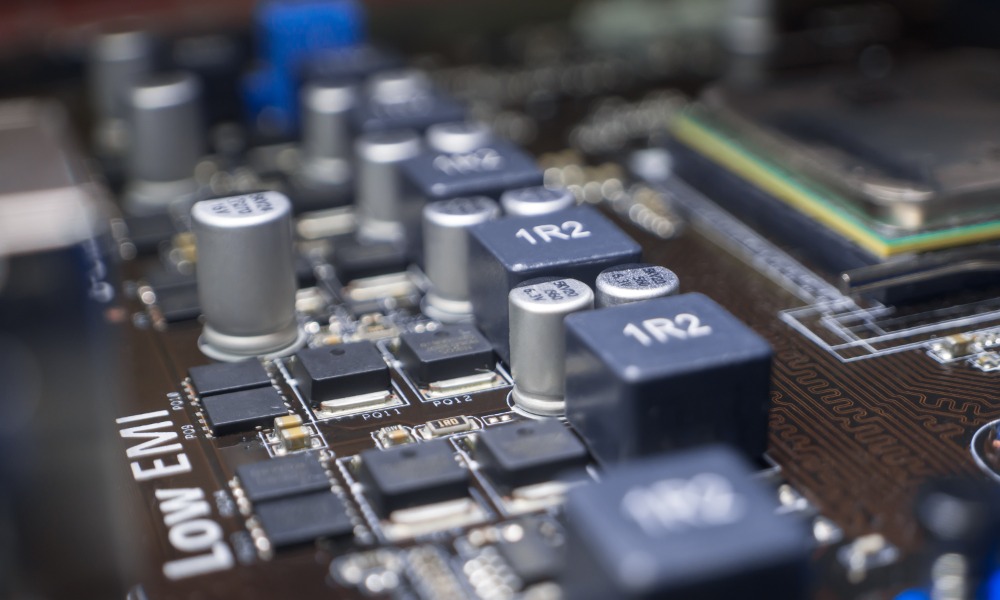 A close-up of the elements of a computer motherboard with identifications like "1R2" and "Low EMI" labeled at the top.
